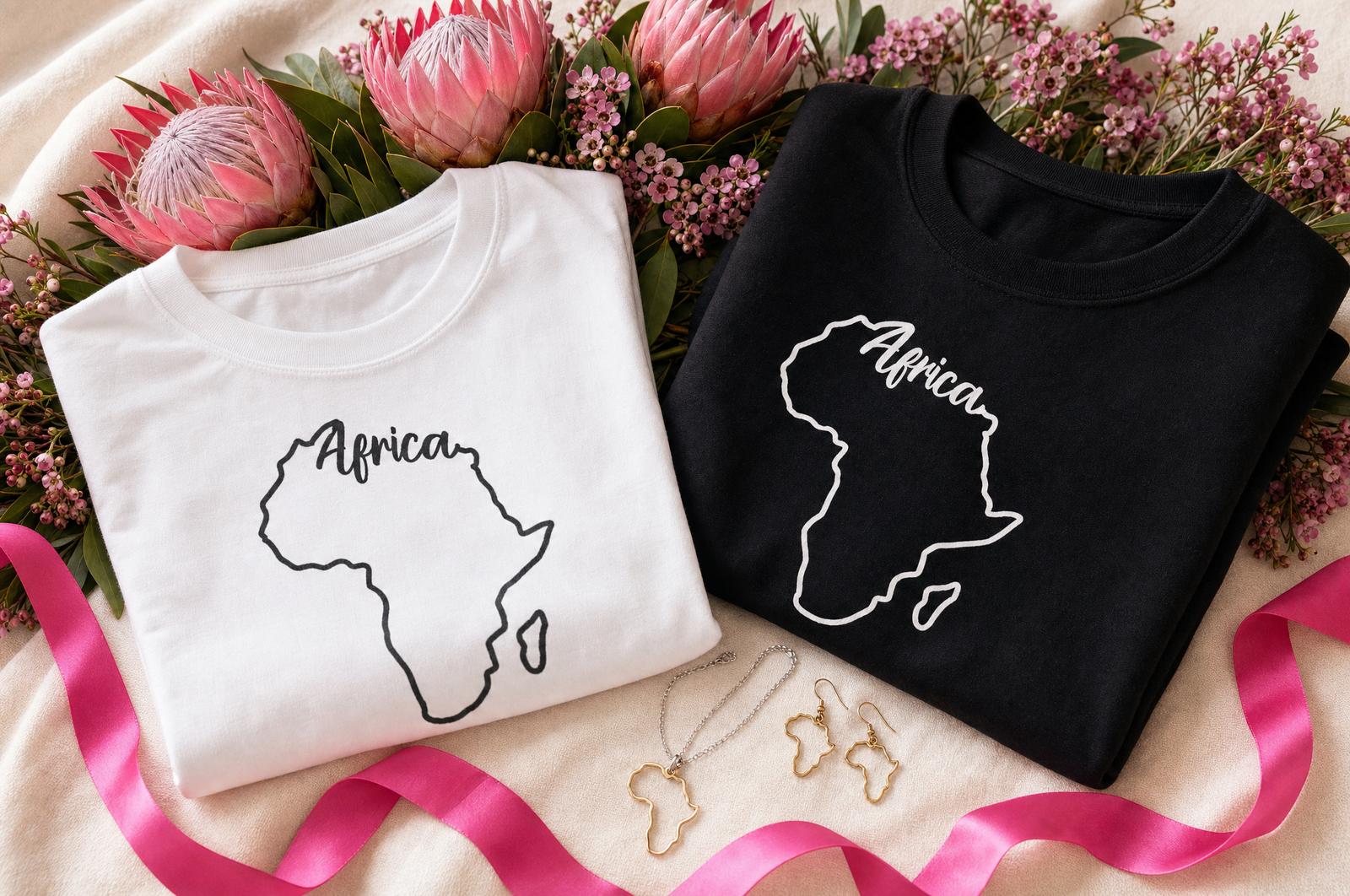 Wild Mongoo Africa print t-shirts, sweatshirt and jewellery styled together with protea flowers for Heritage Month