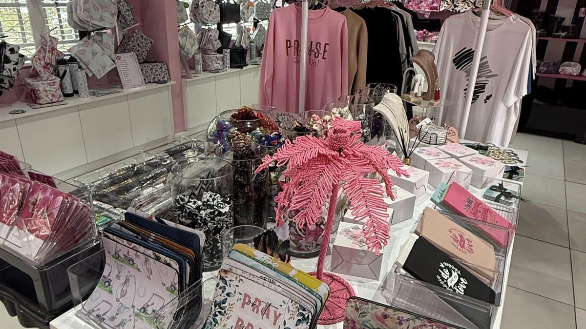 Ethical gifts in South Africa: a table of handmade purses, notebooks and jewellery in the pink Wild Mongoo shop in George