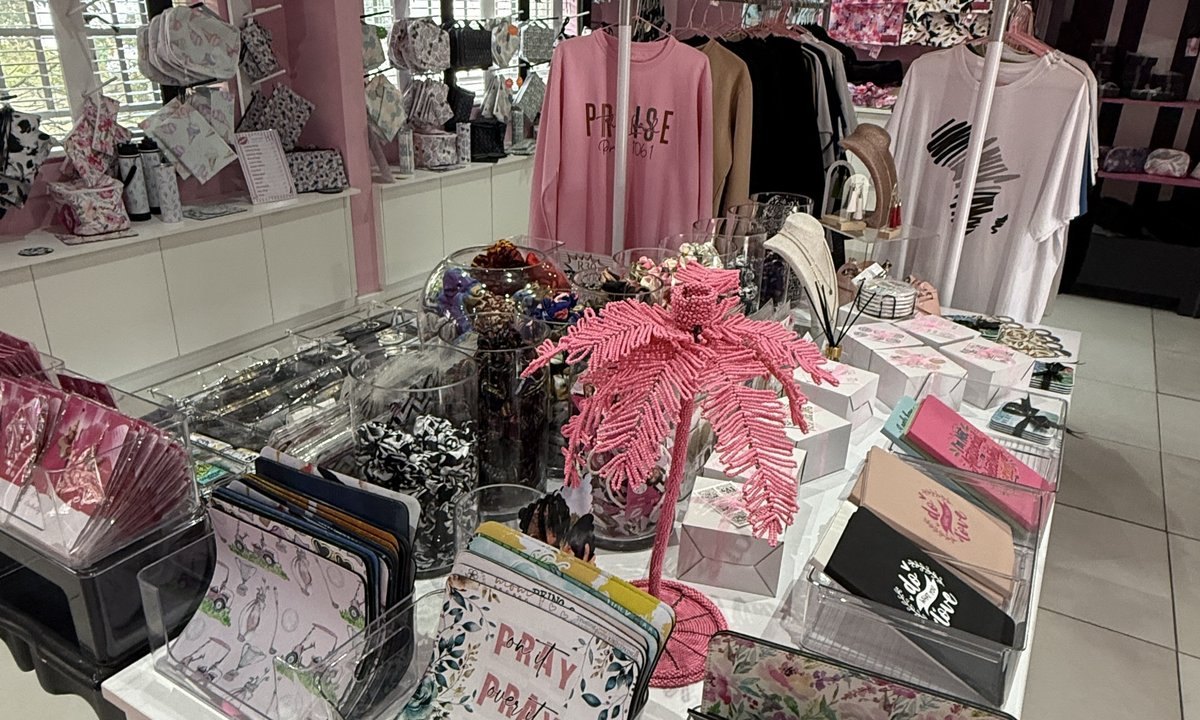 Ethical gifts in South Africa: a table of handmade purses, notebooks and jewellery in the pink Wild Mongoo shop in George